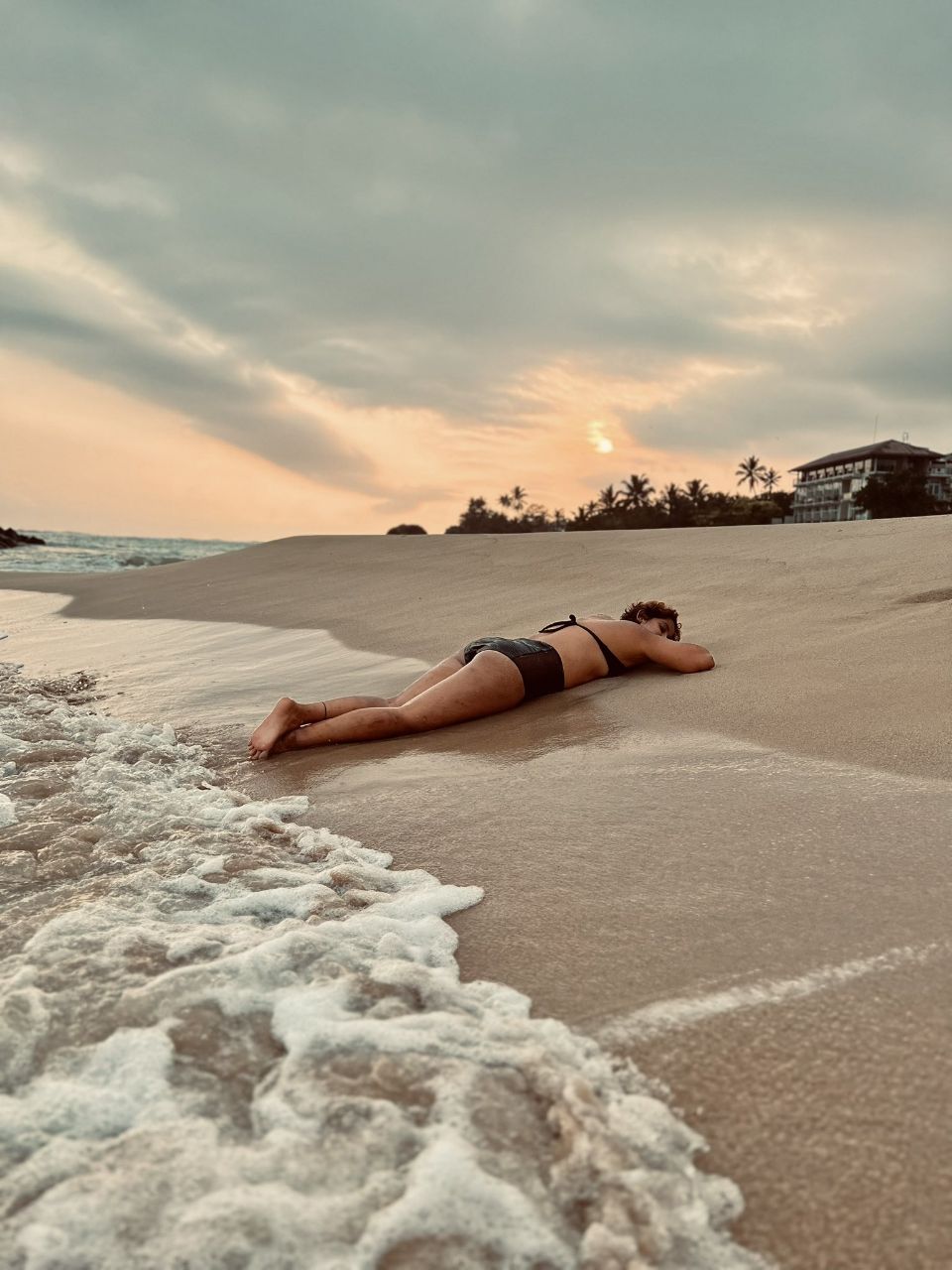 a man lying on a beach
